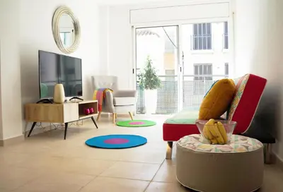 a living room with a couch and a tv at Matilda Home on the Beach in Sitges
