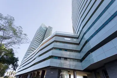 a tall building with glass windows in front of it at Unique Rentals-Seafront Luxe Suites in Barcelona