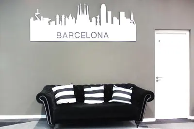 a black couch with striped pillows in a room at Hostal Boutique Khronos in Barcelona