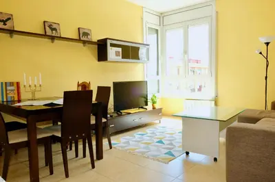 a living room with a dining room table and a television at Apartment Port Forum in Barcelona