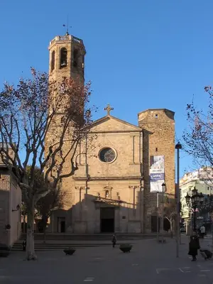 a large church with a clock tower on a street at NEW! Cute apartment near metro in Barcelona