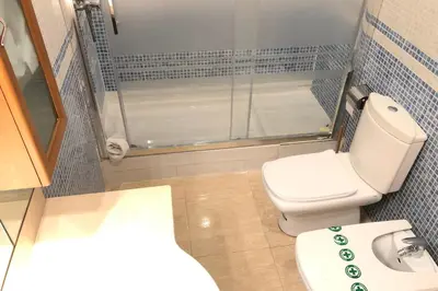 a small bathroom with a shower and a toilet at NEW! Cute apartment near metro in Barcelona