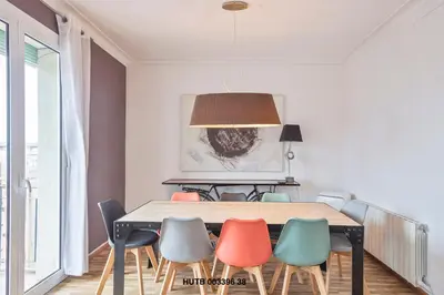 a dining room with a table and chairs at Alcam Urgell in Barcelona