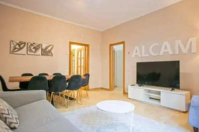 a living room with a couch and a table with chairs at Alcam Calabria in Barcelona