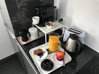 a kitchen counter with a plate of food and a drink at Sunny Flat in Sitges 30 Seconds to Beach, Balcony & Sea Views! in Sitges