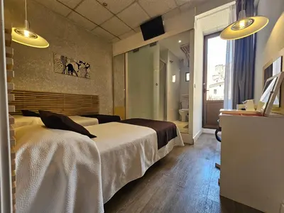 a hotel room with a bed and a bathroom at Hotel Palermo in Barcelona