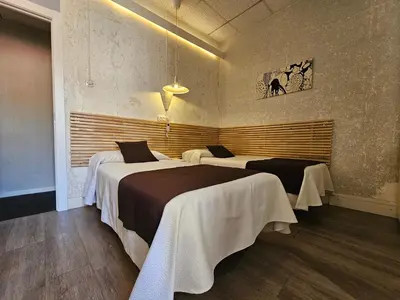 a room with two beds in a room at Hotel Palermo in Barcelona