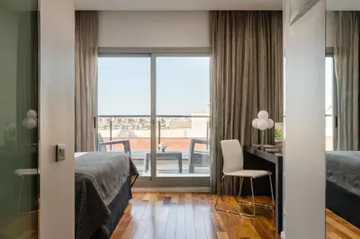 a bedroom with a bed and a desk and a window at Ikonik Lex in Hospitalet de Llobregat