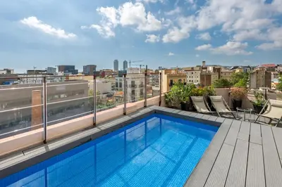 a swimming pool on the roof of a building at Aspasios Poble Nou Apartments in Barcelona