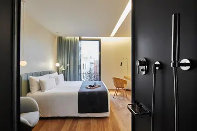 a hotel room with a bed and a table at Ohla Barcelona in Barcelona