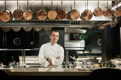 a chef standing in a kitchen with pots and pans at Ohla Barcelona in Barcelona
