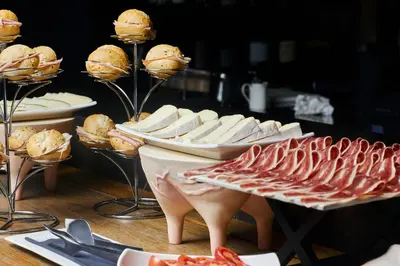 a table topped with plates of food and sandwiches at Ohla Barcelona in Barcelona
