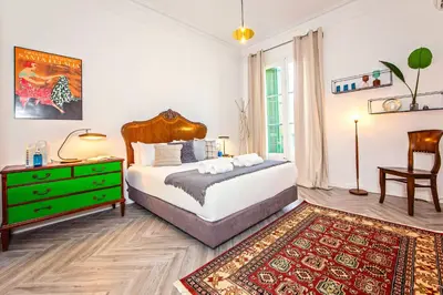 a bedroom with a bed and a green dresser at Sweett - Urgell in Barcelona