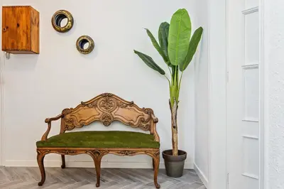 an ornate bench in a room with a plant at Sweett - Urgell in Barcelona