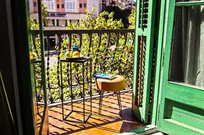 an open door to a balcony with a table and chairs at Sweett - Urgell in Barcelona
