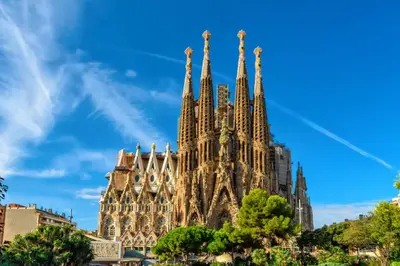 a building with spires on a blue sky at Sweett - Urgell in Barcelona