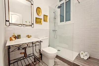 a bathroom with a toilet and a sink and a shower at Sweett - Urgell in Barcelona