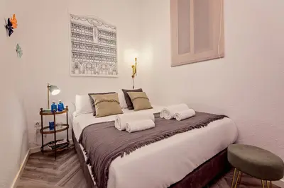 a bedroom with a large bed with two towels on it at Sweett - Urgell in Barcelona