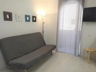 a living room with a couch and a window at BCN 324 Apartment in Barcelona