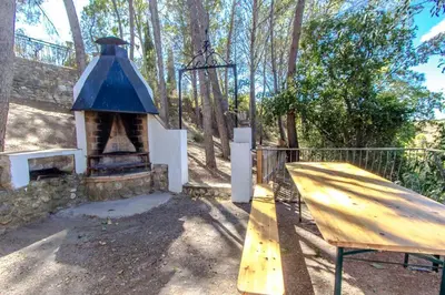 a wooden ramp with a blue roof in a park at Les Canyes Cottage, Private Villa Resort in Piera