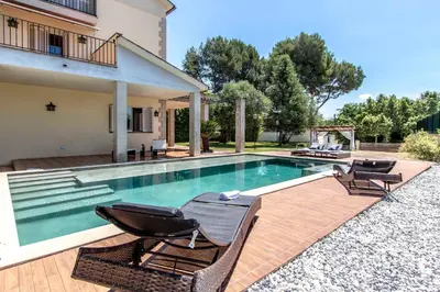 a swimming pool with two chairs and a house at Les Canyes Cottage, Private Villa Resort in Piera