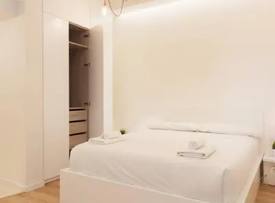 a white bedroom with a bed with white sheets at Alsina · Historical center - Barrio Gótico in Barcelona