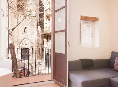 a living room with a window with a view of a church at Alsina · Historical center - Barrio Gótico in Barcelona