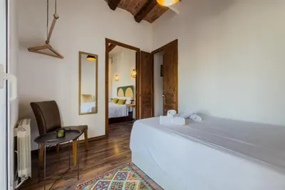 a bedroom with a bed and a table and a mirror at Magalhaes · Trad flat in Poble Sec, near ramblas in Barcelona