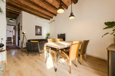 a dining room with a table and chairs at Magalhaes · Trad flat in Poble Sec, near ramblas in Barcelona