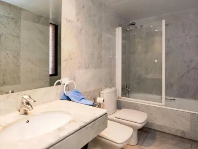 a bathroom with a sink and a toilet and a tub at Apartment Vila Olímpica- Sant Martí - Sardenya by Interhome in Barcelona
