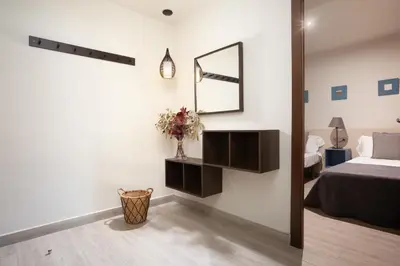 a bedroom with a bed and a mirror on the wall at EasySleep Eixample in Barcelona