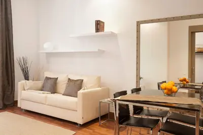 a living room with a couch and a table at EasySleep Gaudi Terrace in Barcelona