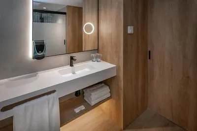 a bathroom with a white sink and a mirror at Hotel Mar Blau in Calella