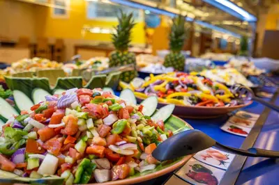 a buffet with plates of food on a table at Hotel Mar Blau in Calella