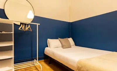 a small room with a bed and a mirror at Mambo Tango in Barcelona