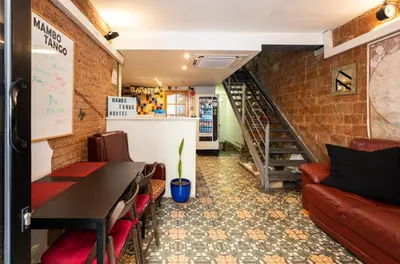 a room with a table and chairs and a staircase at Mambo Tango in Barcelona