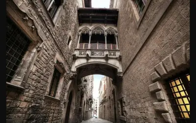 an alleyway in an old building with a balcony at Natura Fira Barcelona in Hospitalet de Llobregat