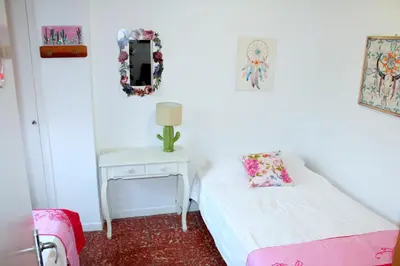 a room with two beds and a table with a mirror at Natura Fira Barcelona in Hospitalet de Llobregat