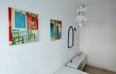 a bathroom with four pictures on the wall at Hawaii Fira Barcelona in Hospitalet de Llobregat
