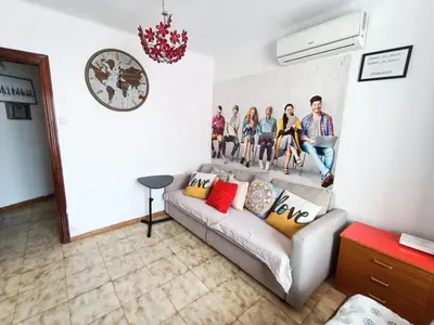 a group of people sitting on a couch in a living room at Hawaii Fira Barcelona in Hospitalet de Llobregat