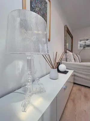 a white living room with a table with a lamp at Stay U-nique Apartments Urquinaona II in Barcelona