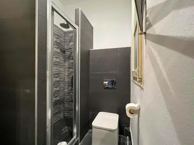 a bathroom with a toilet and a glass shower at Stay Unique Apartments Cent in Barcelona