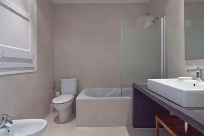 a bathroom with a toilet and a tub and a sink at Central and Spacious Family Apartment in Barcelona
