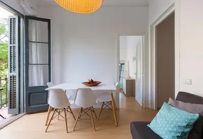 a living room with a white table and chairs at Cozy Flat With Unbeatable Views to Sagrada Familia in Barcelona