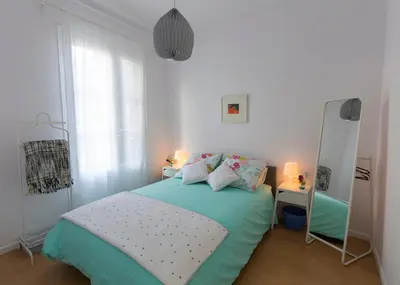 a small bedroom with a bed and a mirror at Cozy Flat With Unbeatable Views to Sagrada Familia in Barcelona