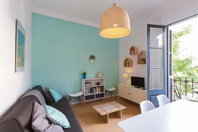 a living room with a couch and a table at Cozy Flat With Unbeatable Views to Sagrada Familia in Barcelona