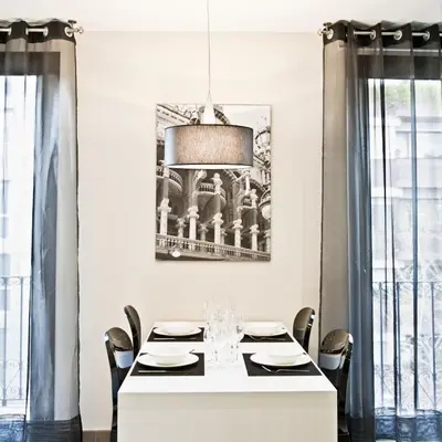 a dining room with a white table and chairs at Up Suites BCN in Barcelona