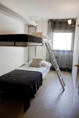 a bedroom with a bunk bed and a ladder at Up Suites BCN in Barcelona