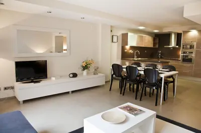 a kitchen and living room with a table and chairs at Up Suites BCN in Barcelona