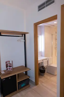 a bathroom with a sink and a toilet and a mirror at Hostal Paris in Barcelona